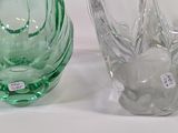 two glass vases sitting next to each other on a table