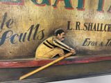 a statue of a baseball player leaning against a sign