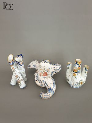three vases that are sitting next to each other on a table