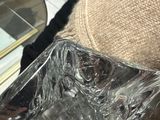 a person holding a glass plate with a piece of cake in it