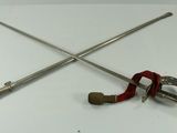 two swords and a clamp on a white table