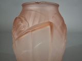 a pink glass vase with a leaf design on it