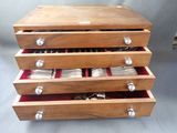 a wooden box with silverware in it on a table