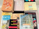 several books are stacked on top of each other on a table