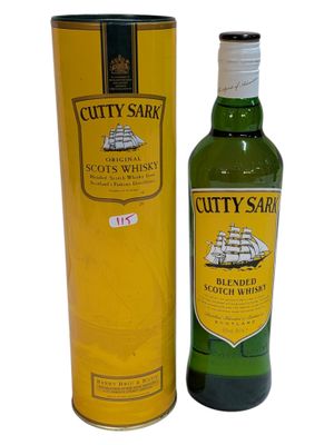 a bottle of cutty sark scotch whisky next to a canister
