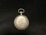 an old silver pocket watch with a chain on a black background