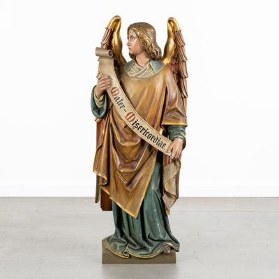 an image of a statue of an angel holding a scroll