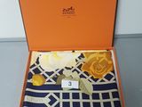 an orange box with a blue and white scarf in it