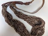 brown rope with a leather strap on a white background