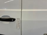 a close up of a door handle on a white van