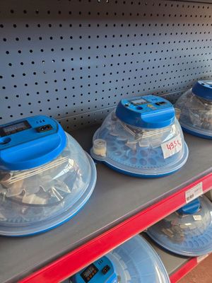 many plastic containers that are on a shelf in a store