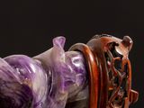 a close up of a figurine of a horse on a black background