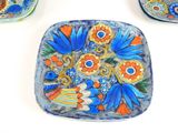 a plate with flowers on it sitting on a table