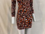 a mannequin wearing a brown and black dress on a white mannequin