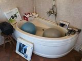 a bathtub with a ball in it in a bathroom