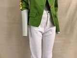 the mannequin is wearing a green jacket and white pants
