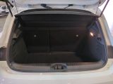 a trunk of a white car with its doors open