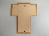 a close up of a wooden cross on a white surface