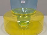 a yellow and blue glass bowl on a yellow plate