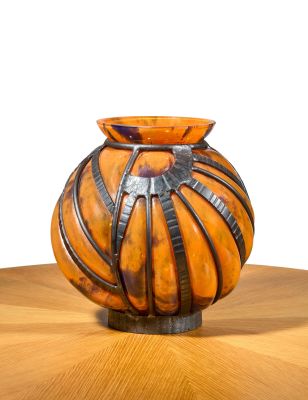 a vase that is sitting on a table with a white background