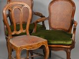 two chairs and a table with a green cushion on it