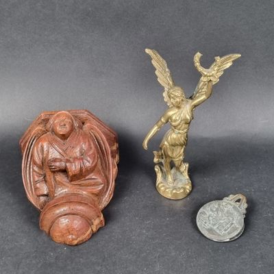 two small figurines of angels and a coin on a table