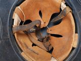 a baseball glove and a baseball mitt inside of a cupcake tin