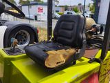 a yellow fork truck with a seat on the back of it
