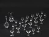 a lot of wine glasses and a pitcher on the table
