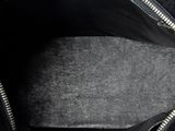 the inside of a black purse with a zipper on it