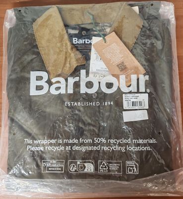 a barbour shirt wrapped in plastic on a table