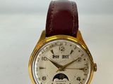 an image of a close up of a wrist watch on a white surface