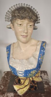 a statue of a woman in a blue dress on a table