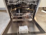 a dishwasher that is sitting in the middle of the floor