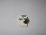 a close up of a ring with a blue topaz stone on it