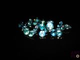 some very pretty blue and white diamonds on a black surface