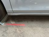 a car that has been painted red on the side of the road