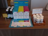 many bottles of medicine sitting on a desk in a room