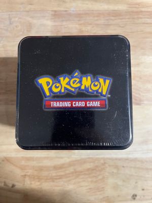 a black tin box with a pokemon trading card game logo on it