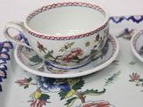 two cups and saucers on a tray on a table