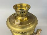 a gold vase with a brass handle on a white background