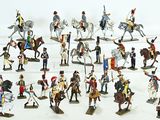 a lot of figurines that are on a white surface