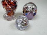 three glass figurines of different shapes and sizes
