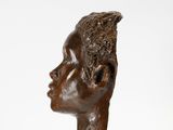 sculpture of a head of a woman on a white background