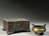 a small box and a small bowl sitting next to each other