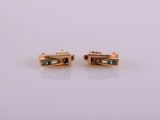 a pair of gold plated earrings with black stones