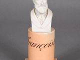 a statue of a man with a beard sitting in a cup