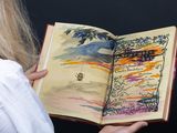 a woman holding an open book in her hands