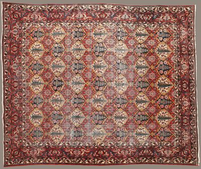 un ancien tapis persan à motifs rouges et bleus