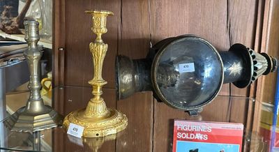 a glass shelf with a lamp and a book on it